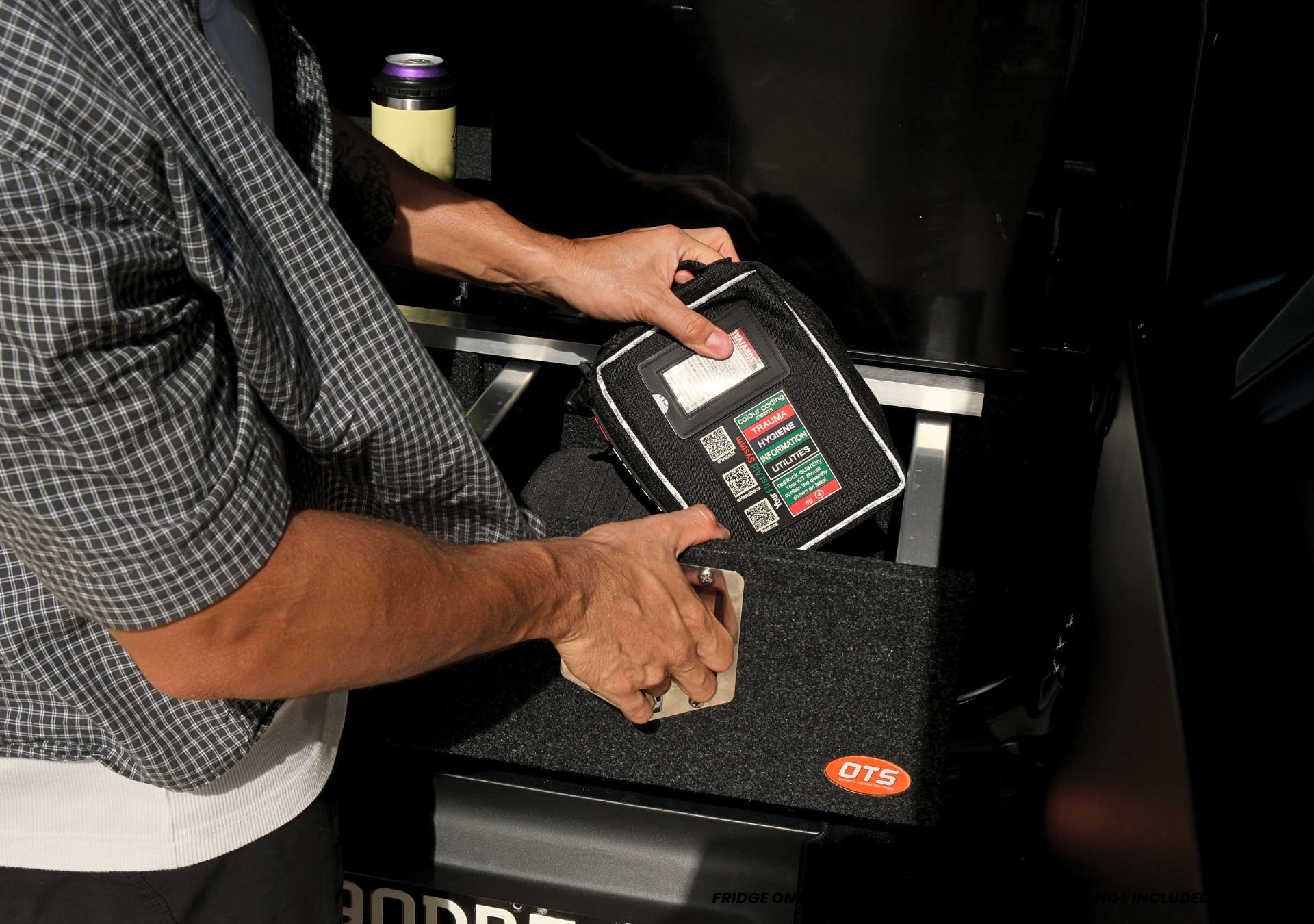 Suzuki Jimny XL Drawer System and Wing Kit carpeted rear drawer with hands placing a tool case into cargo